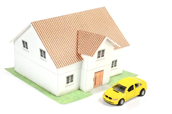 Speelgoedauto en huis op witte achtergrond — Stockfoto