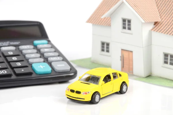 Toy car and house with calculator — Stock Photo, Image