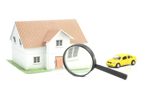 Toy car and house with magnifier — Stock Photo, Image