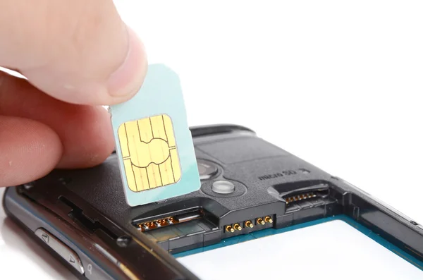 Sim card and cell phone — стоковое фото