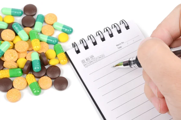 Medicina e bloco de notas com caneta — Fotografia de Stock