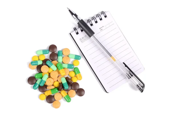 Medicinali e blocco note con penna — Foto Stock