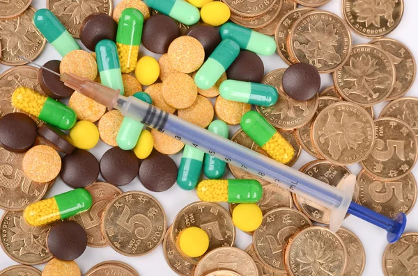 Medicine and coins — Stock Photo, Image