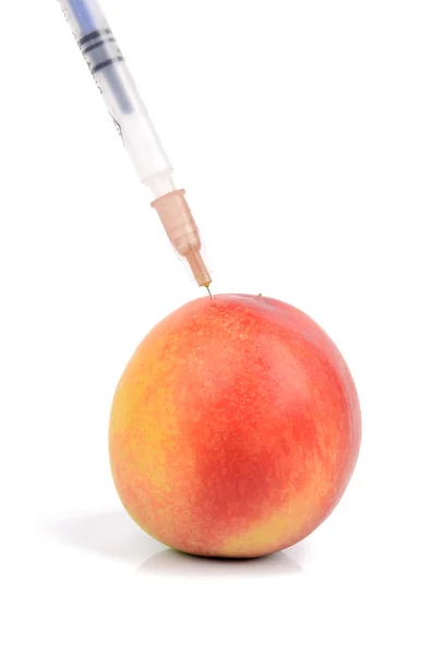 Peach and syringe — Stock Photo, Image