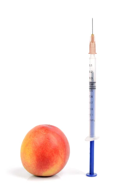 Peach and syringe — Stock Photo, Image