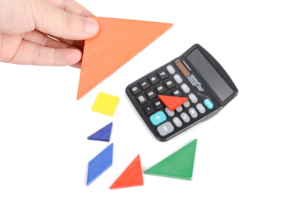 Tangram e calculadora sobre fundo branco — Fotografia de Stock