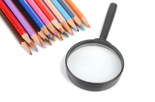 Color pencils and magnifier — Stock Photo, Image