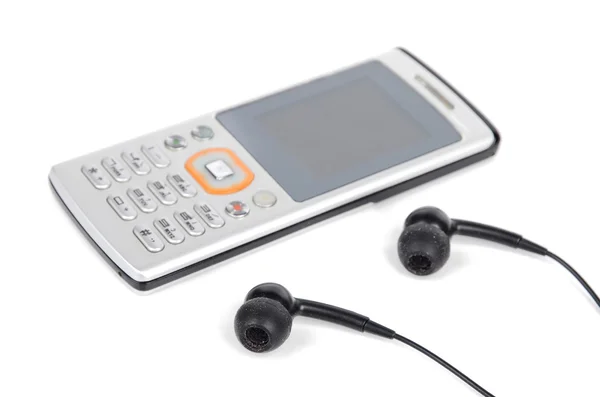 Teléfono móvil y auricular sobre fondo blanco — Foto de Stock