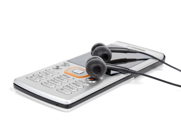 Telefone celular e fone de ouvido no fundo branco — Fotografia de Stock