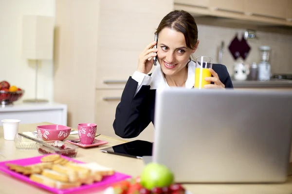 Businesswoman working at home during breakfast — Stock Photo, Image