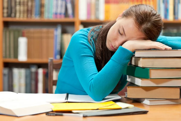 Sleeping girl in library — Stock Photo, Image