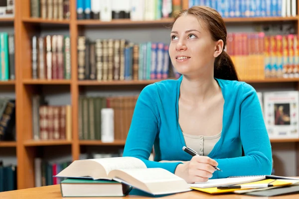 Dreamy girl in library — Stock Photo, Image