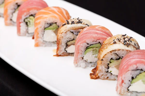 Assorted sushi on white plate — Stock Photo, Image