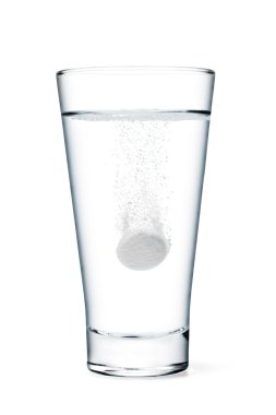 Fizzy tablet in glass of water clipart