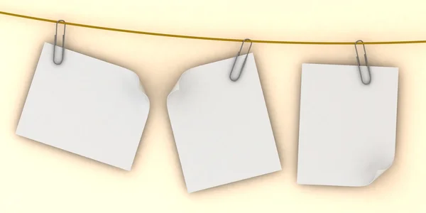 Paper are hanging in the row on the peach background — Stock Photo, Image