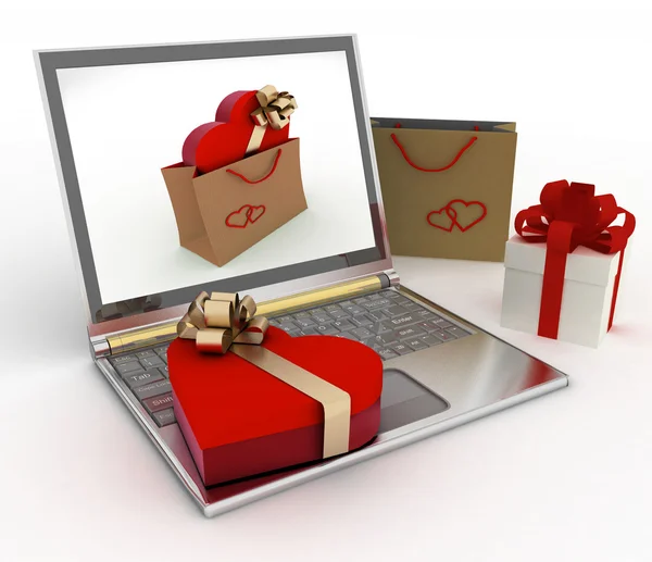 Caja como forma de corazón con un arco de oro se encuentra en un ordenador portátil —  Fotos de Stock