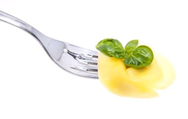 Tortellini on a fork isolated on white clipart
