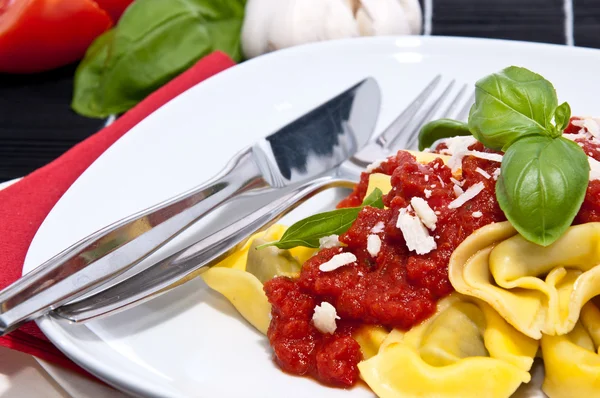 Tortellini with ingredients in the background — Stock Photo, Image