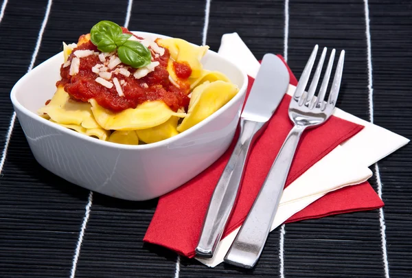 Tortellini in a bowl on black background — Stock Photo, Image
