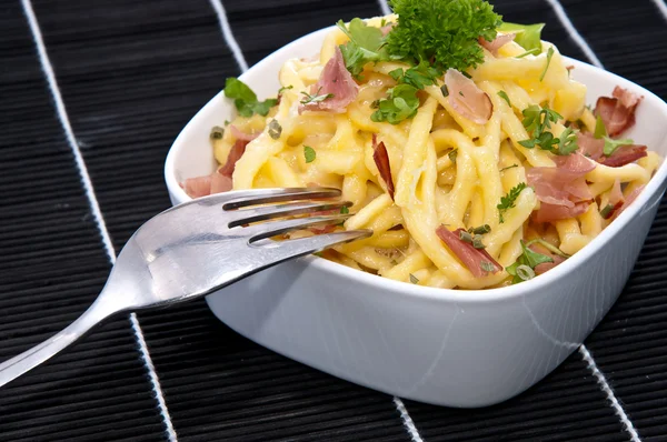 stock image Cheese Spaetzle in a Bowl (on black)