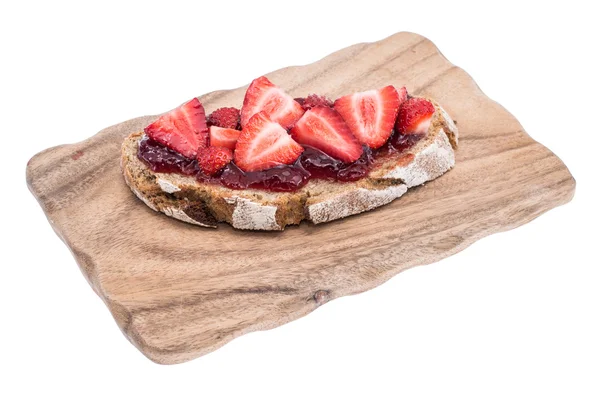 Bröd med jordgubbssylt på skärbräda — Stockfoto
