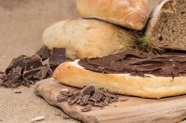 stock image Chocolate Creme on a bun (rustic background)