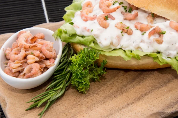 Roll with Shrimp-Salad on a cutting board — Stock Photo, Image