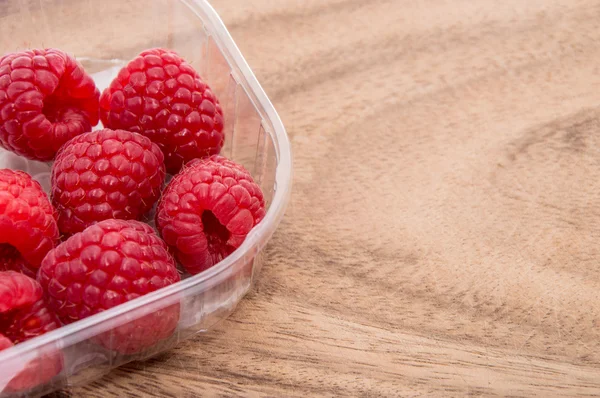 stock image Raspberries on wooden background