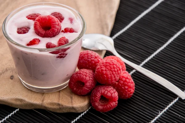 Raspberry Yogurt on black background — Stock Photo, Image