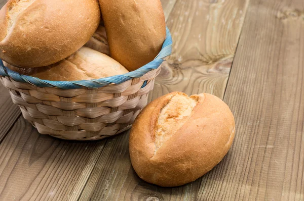 stock image Basket with buns on wooden background