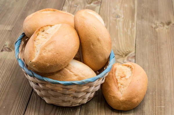 stock image Basket with buns on wooden background