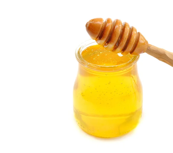 Мед в стеклянной банке — стоковое фото