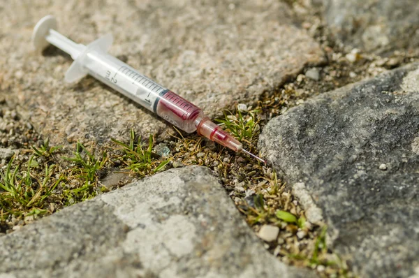 Stock image Syringe just used by a drug addict