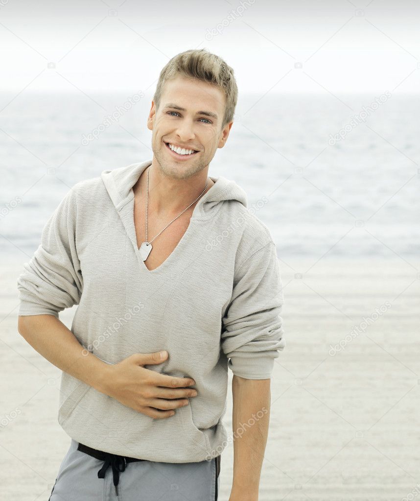 Young man with smile on beach