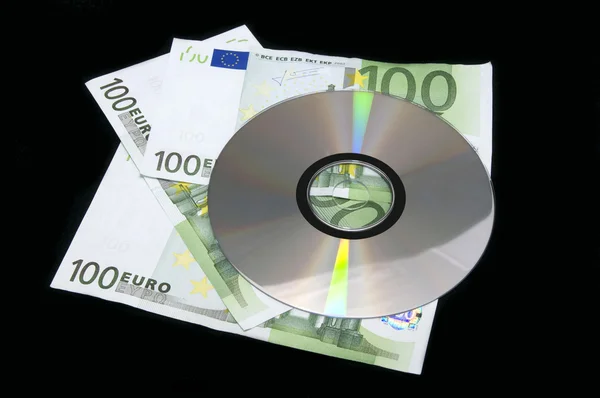 Pengar och cd-rom — Stockfoto
