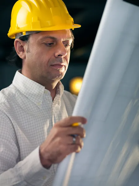 Volwassen zakenman werkt als engineer houden blauwdrukken — Stockfoto