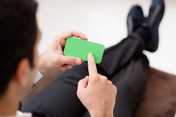 Geschäftsmann nutzt Smartphone mit grünem Bildschirm für Web und E-Mail — Stockfoto