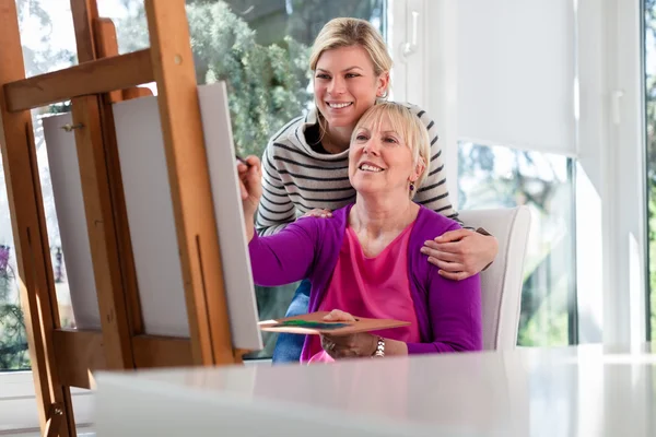 Women portrait with happy mom painting and daughter smiling — Stock Photo, Image