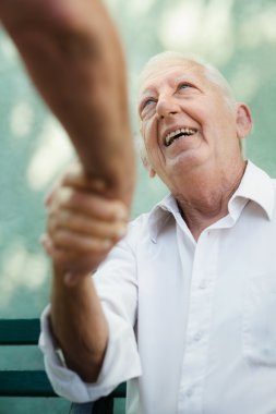 Group of happy elderly men laughing and talking clipart