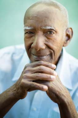 Closeup of happy old black man smiling at camera clipart