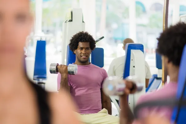Jonge opleiding en trainen in de fitnessclub — Stockfoto