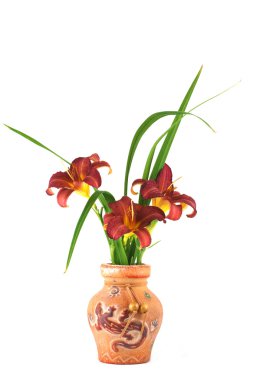 A bouquet of burgundy daylily flowers in a clay vase clipart