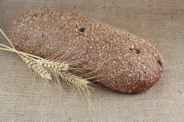 Wholemeal bread with three ears of wheat clipart