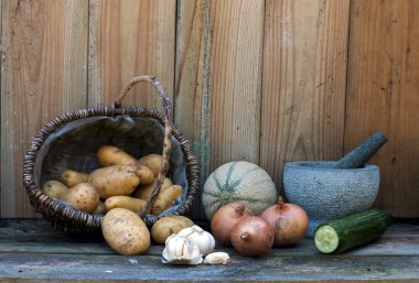 Stil life with patatoes onions and other fruit clipart