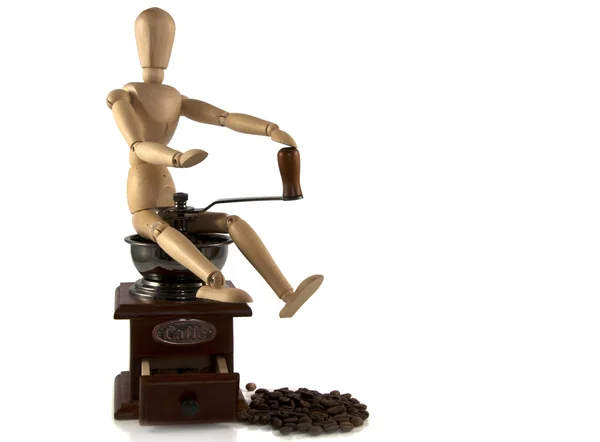 Деревянная кукла сидит на кофеварке — стоковое фото