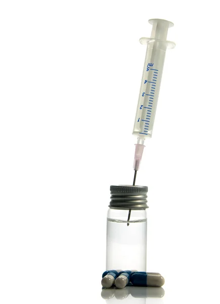 Medical needle in bottle with medicine — Stock Photo, Image