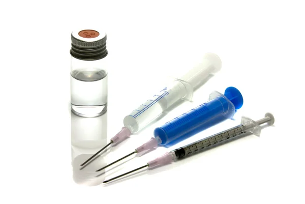 Medical needle in bottle with liquid — Stock Photo, Image