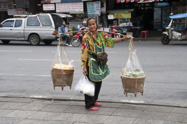 Woman selling food on the streets in Bangkok clipart