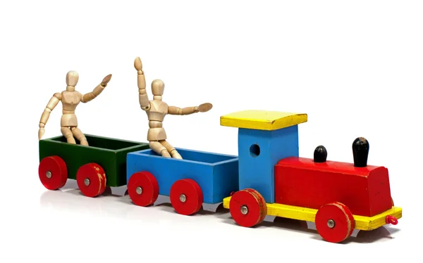 Two wooden dolls sitting on a train — Stock Photo, Image