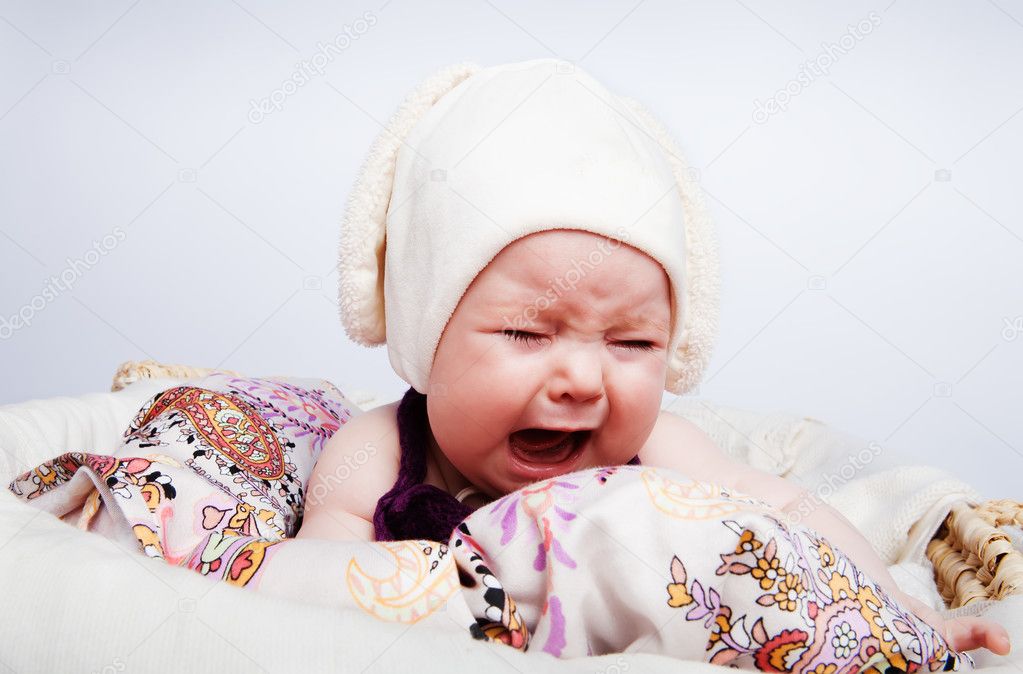 Cute baby in the hat crying out loud